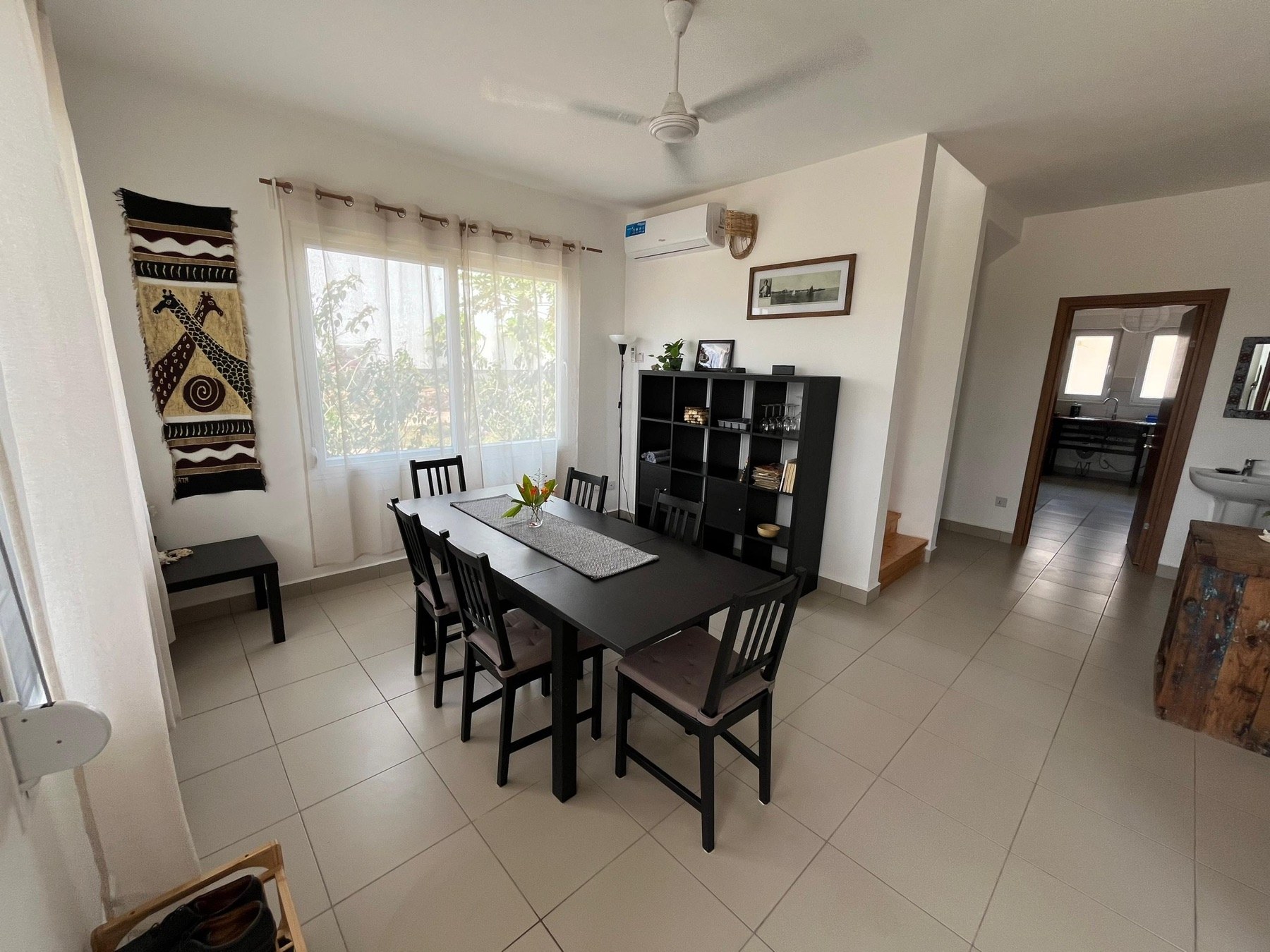 Bright dining area with large table and air conditioning