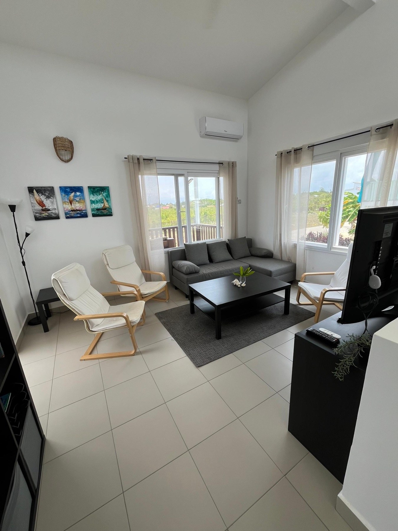 Spacious bright living room with seating and air conditioning