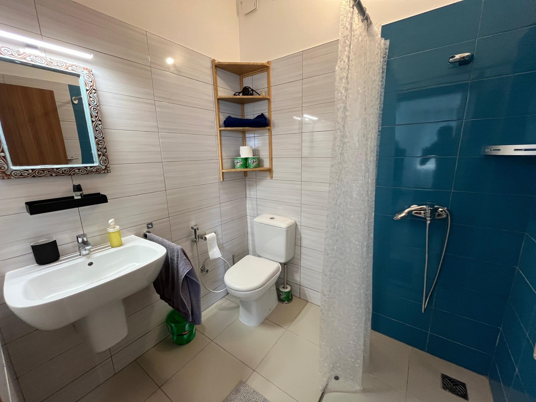 Modern bathroom with turquoise shower