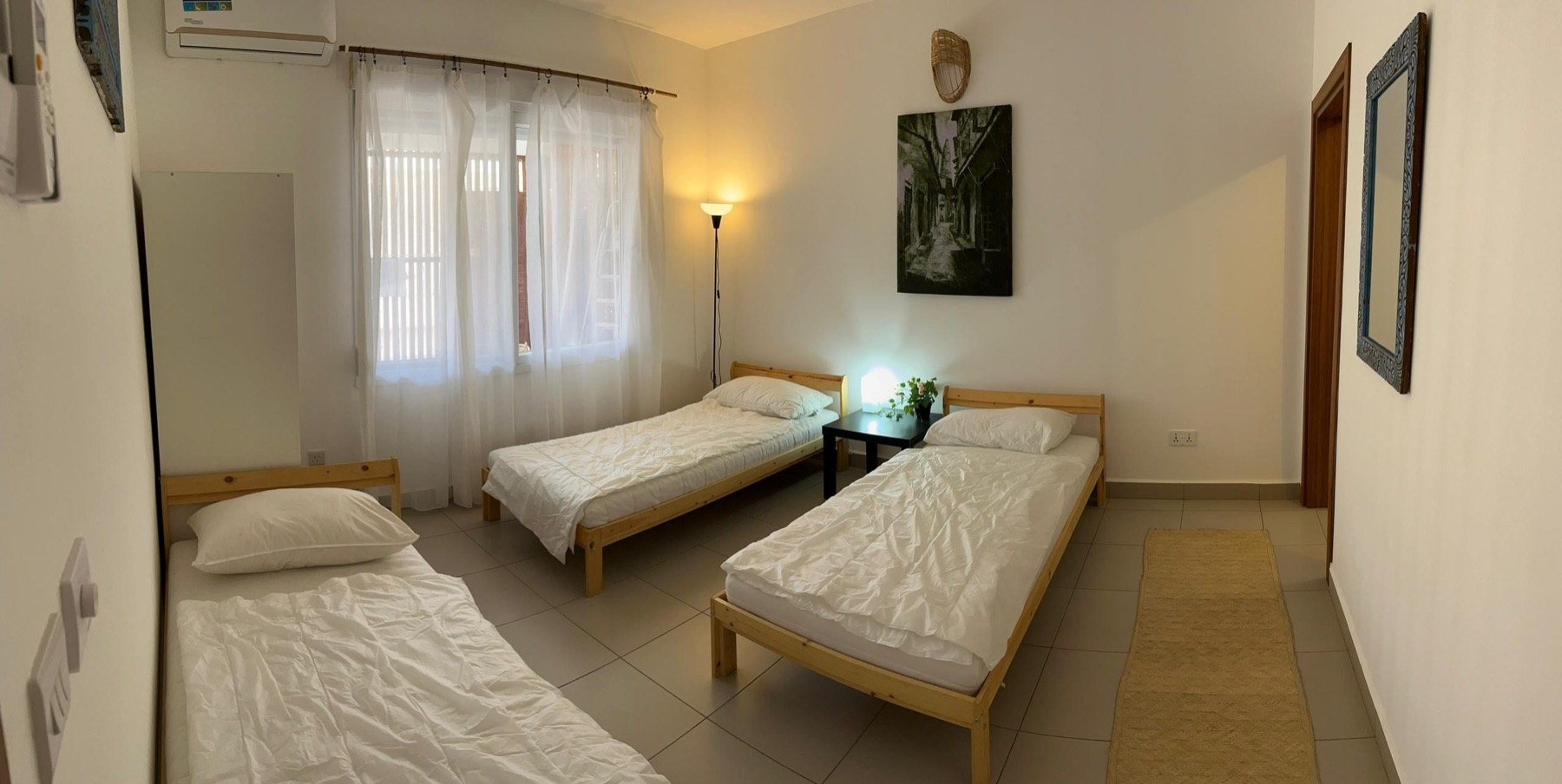 Ground-floor bedroom with three single beds